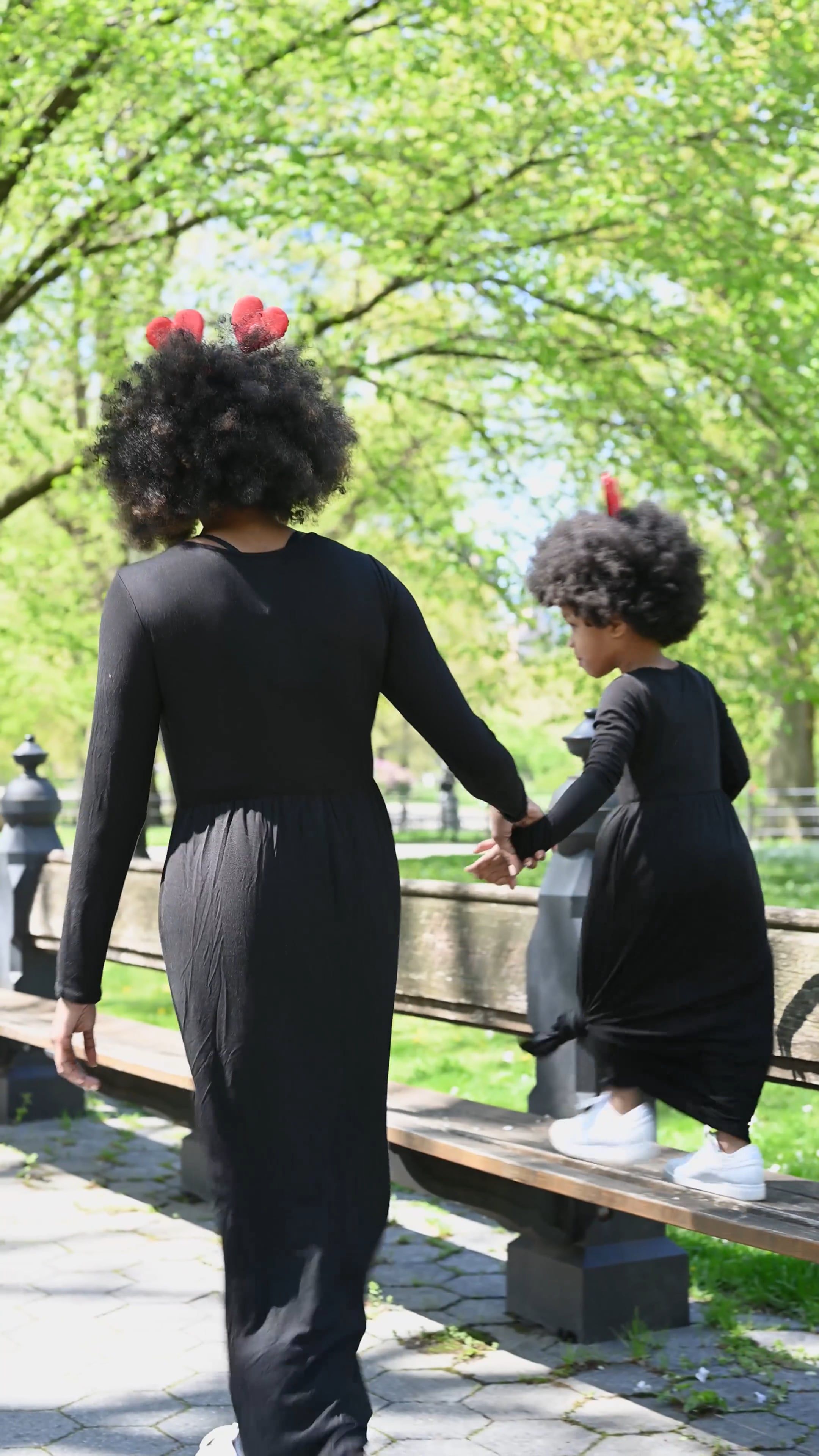 Mother and Daughter Holding Hands while Walking in the Park Free Stock ...