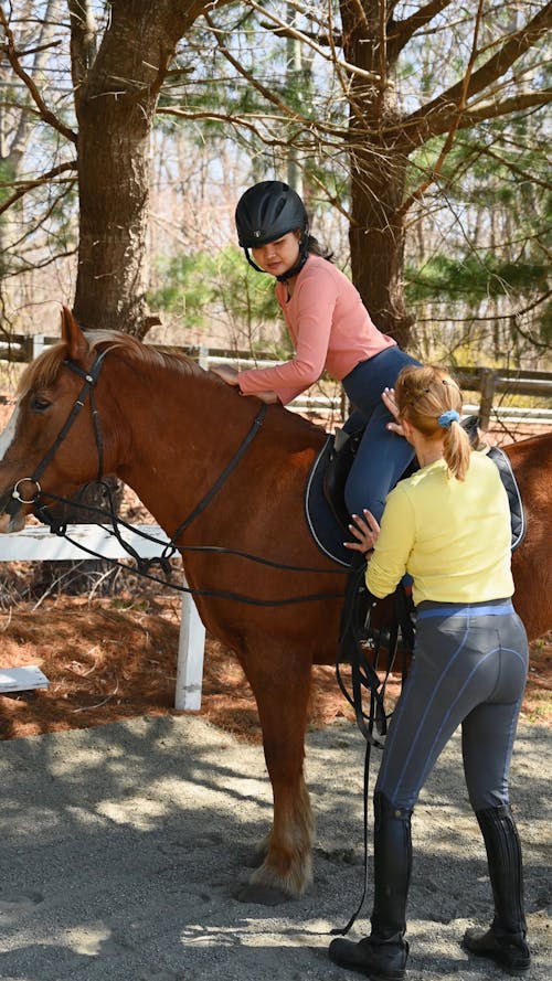 Woman Teaching How to Ride a Horse