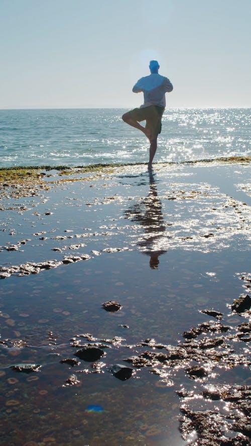 Man Doing Yoga at the Beach