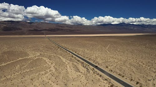 A Car Driving on a Road in Death Valley