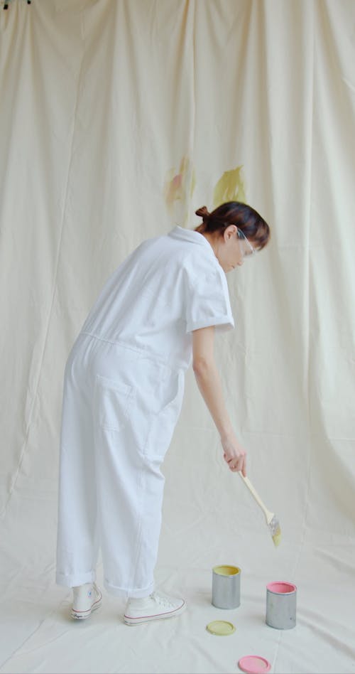 A Man Painting on a Piece of Cloth