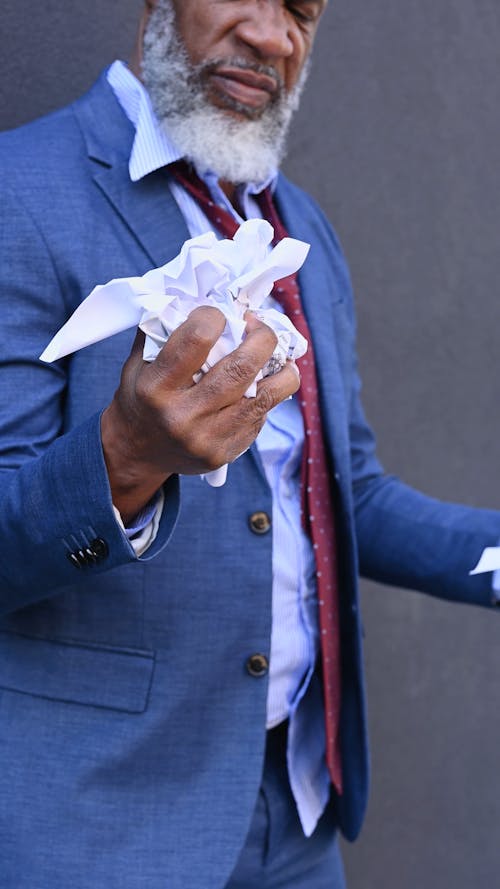 Man Crumpling a Paper