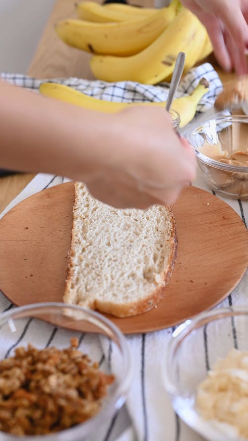 Person Putting Peanut Butter on Bread