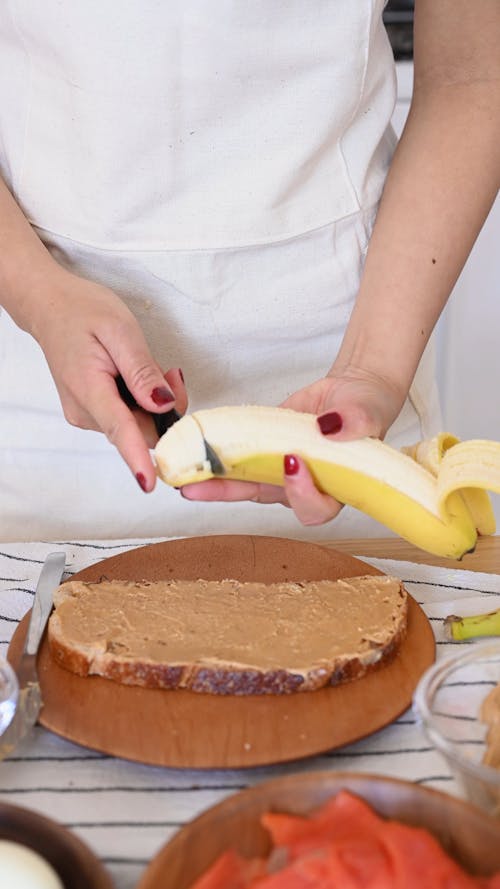 A Person Slicing a Banana