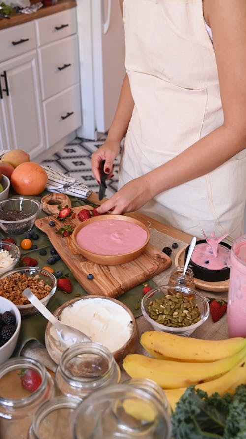 A Person Making Strawberry Smoothie