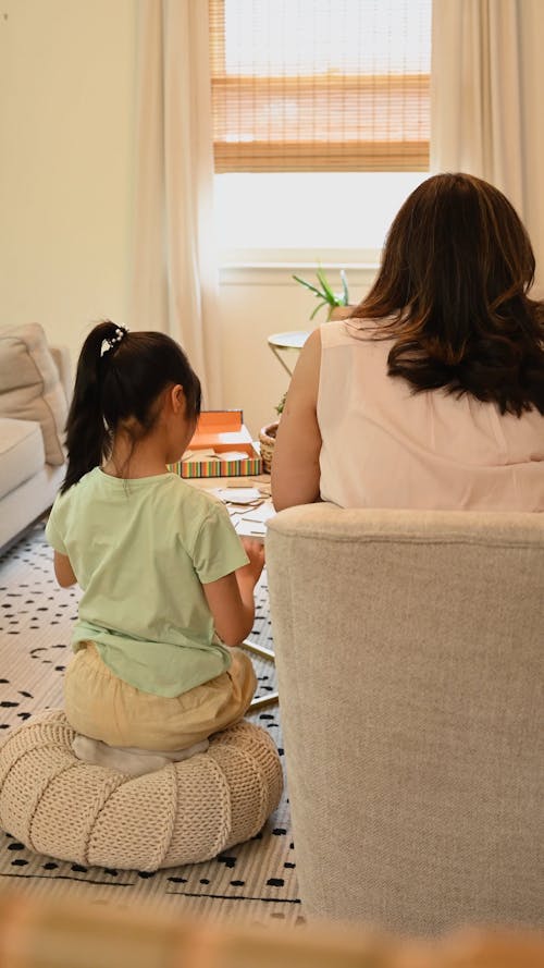 Back View of A Mother and Daughter Bonding at Home