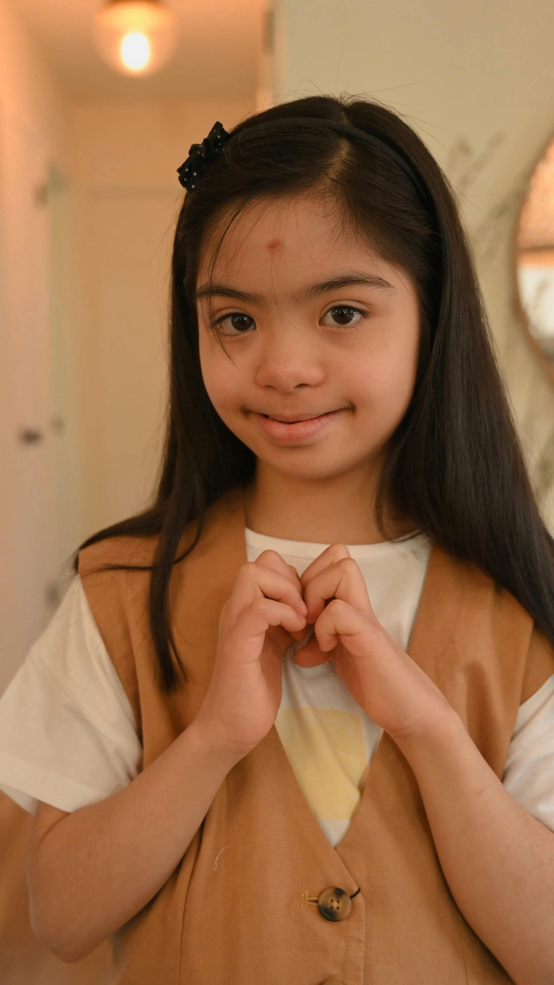 A Young Girl Doing a Hand Heart · Free Stock Video