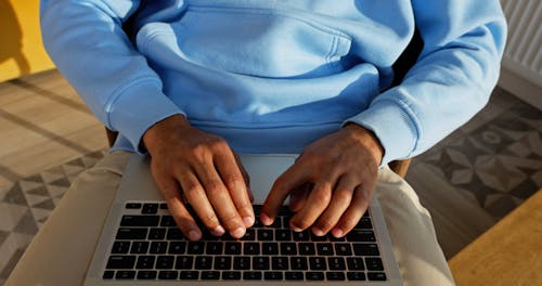 Man Typing on his Laptop