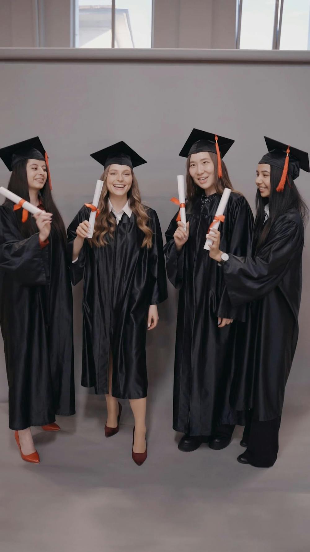 People Wearing Graduation Gown Holding a Banner · Free Stock Video