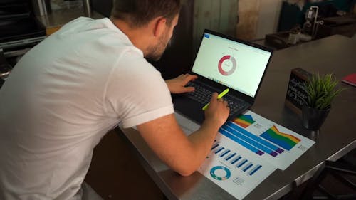 Man Making a Graph on Laptop