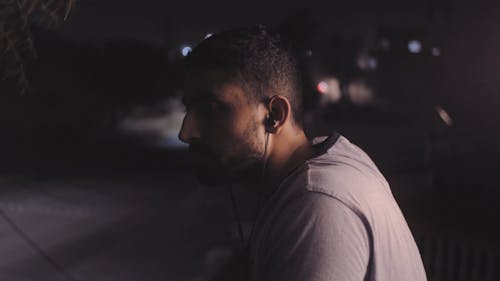 Cinematic Shot of a Man Sitting in the Dark