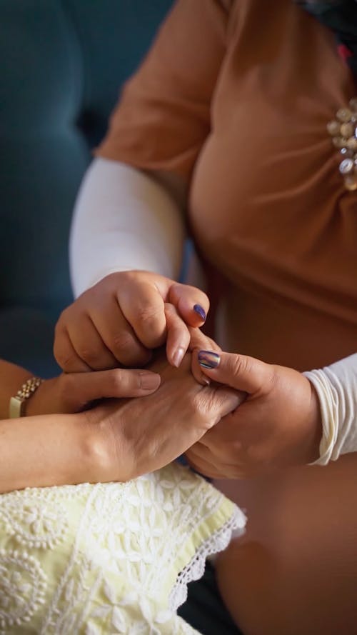 Two Females Holding Hands