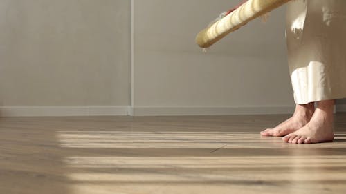 A Person Unrolling a Prayer Rug