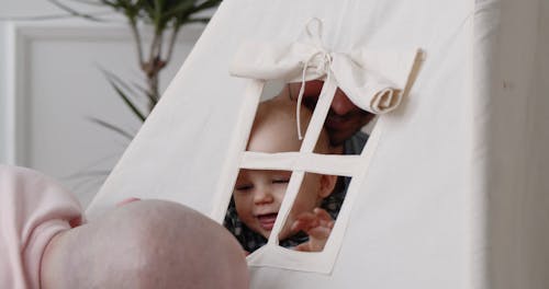 Loving Couple and Their Baby Playing Together