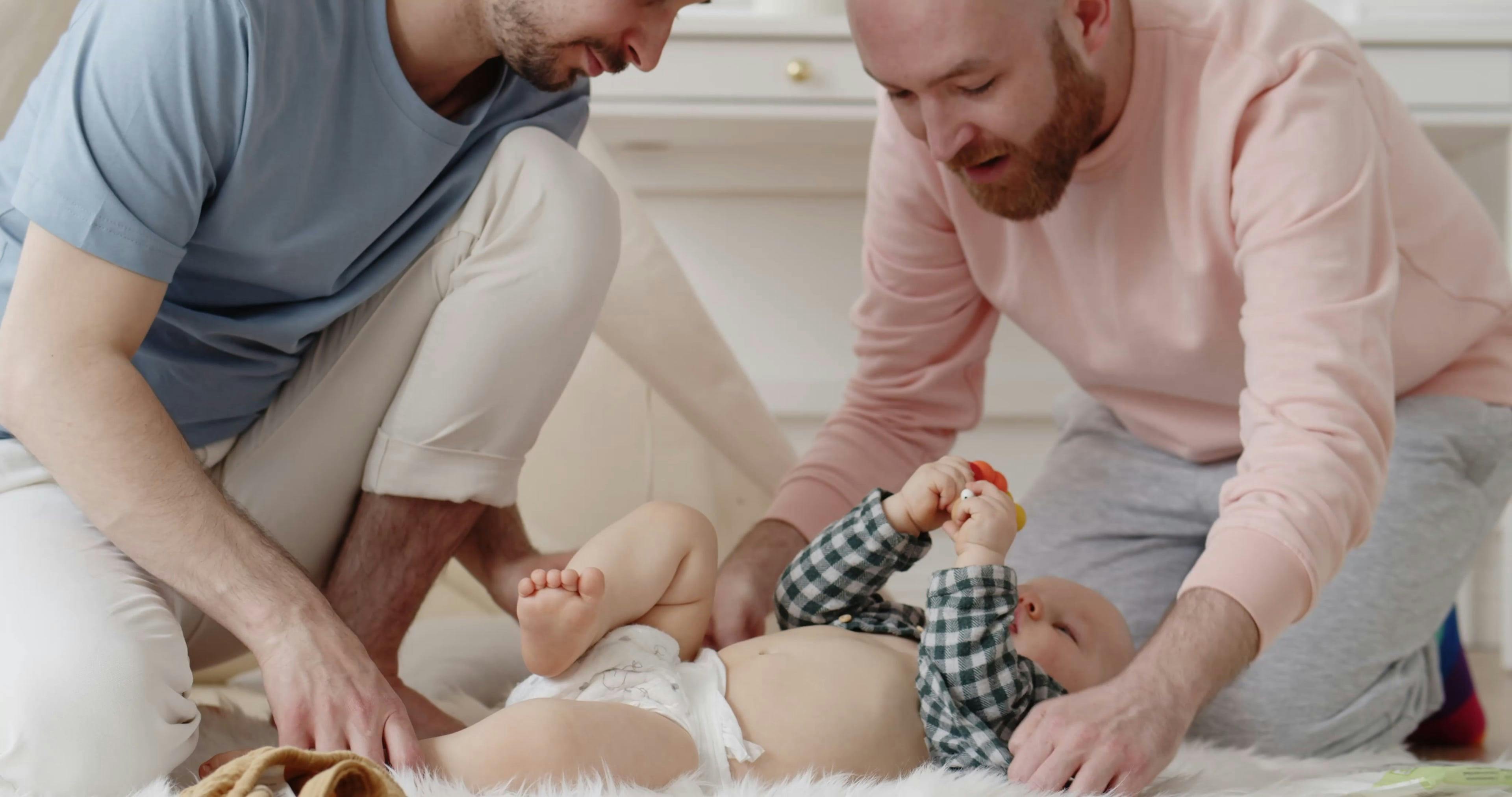 Parents Putting on the Shirt of the Baby · Free Stock Video