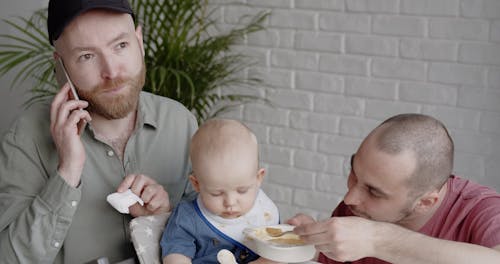 Man Feeding a Baby Boy