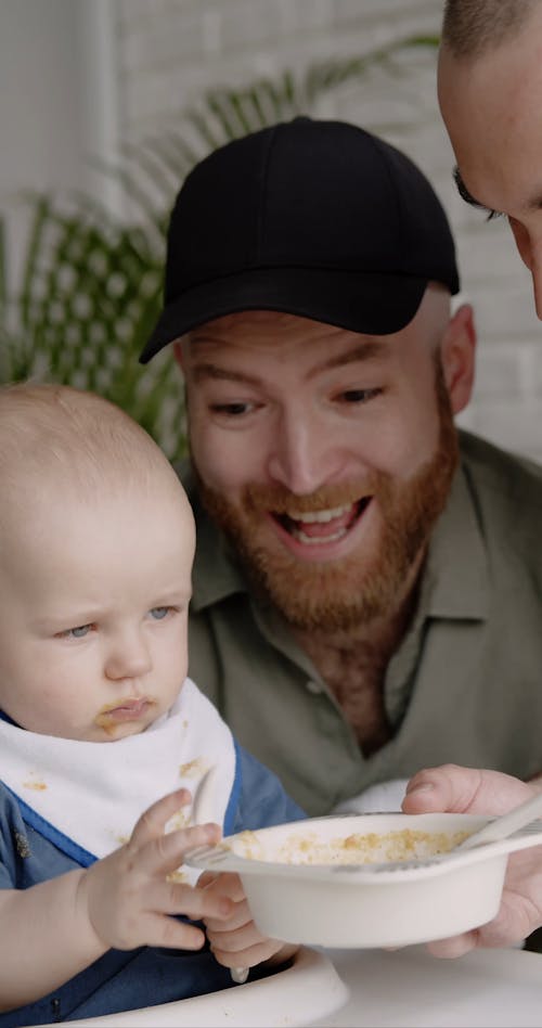 Dad and Dad Feeding a Baby