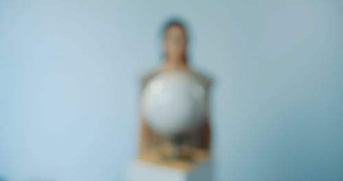 Woman Holding a Globe