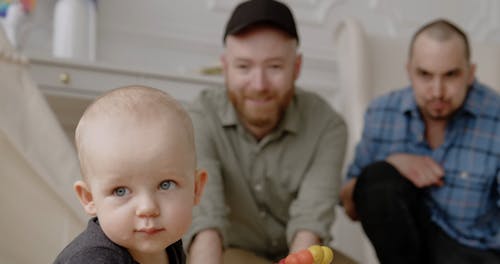 Men Playing with a Baby Boy