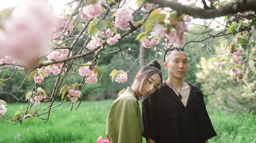 Young Eastern Couple Under Cherry Blossom Tree