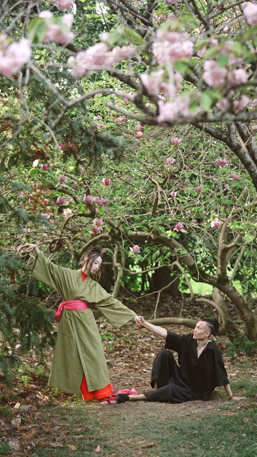 Man And Woman Dancing Under Flowering Trees
