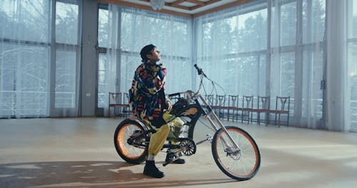 A Man Rapping while Sitting on a Bike