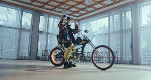 Man Rapping while Riding on a Customized Bike