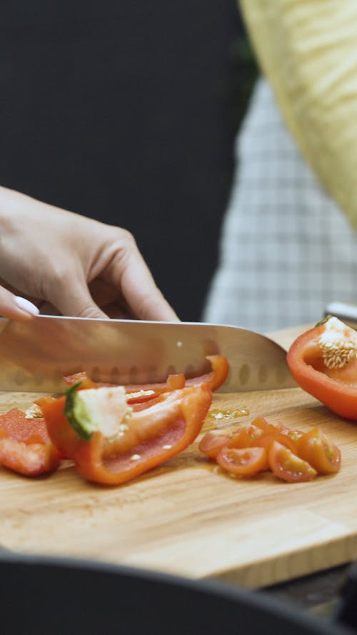 People in Kitchen Chopping Bell Pepper