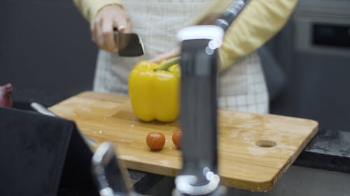 Close Up Shot of a Woman Cutting Capsicum