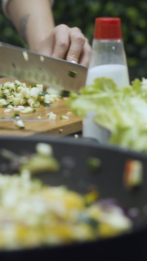 Close Up Shot of a Girl Cutting Vegetables