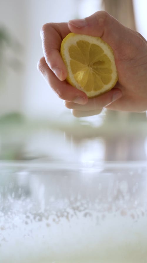 Person Squeezing the Lemon