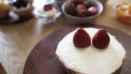 Person Putting Berries on Top of the Bread