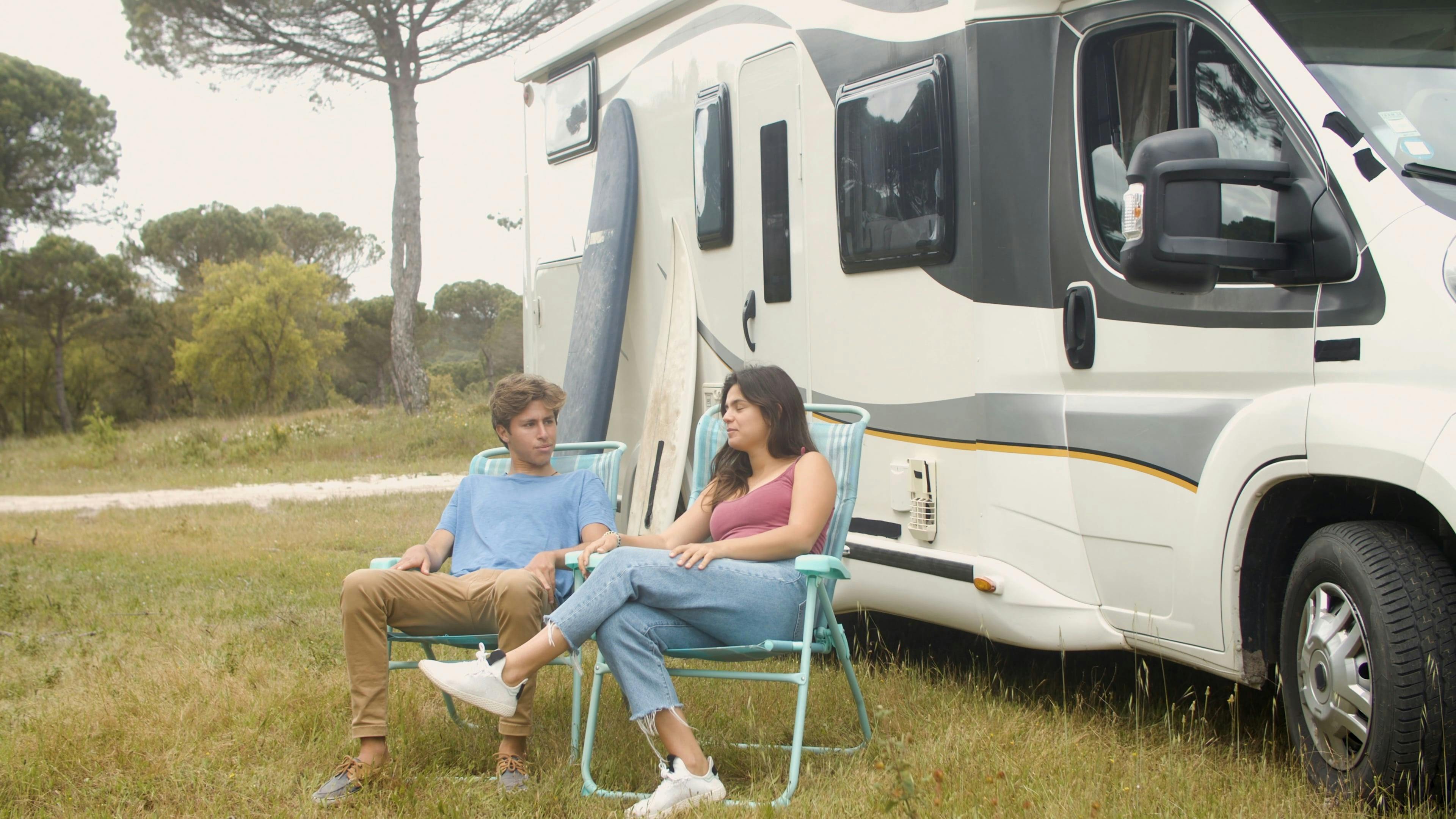 Young Couple Sitting Outside Their Camper Van · Free Stock Video 2042