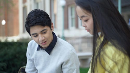 Man and Woman Talking while Studying