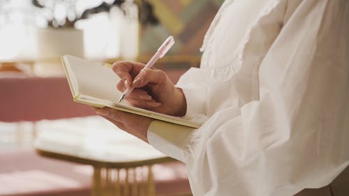 Woman Writing on a Notebook