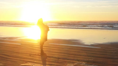 A Woman and Her Dog on the Shore