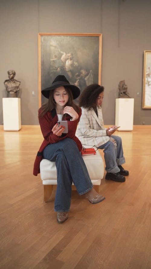 Women Using Cellphone at a Museum