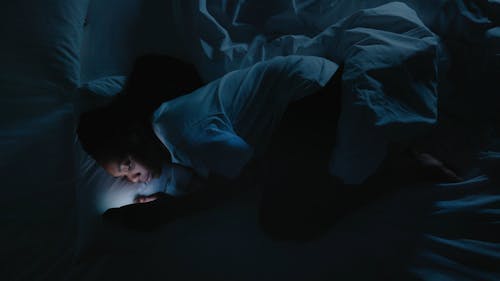 Woman using Smartphone before Sleeping