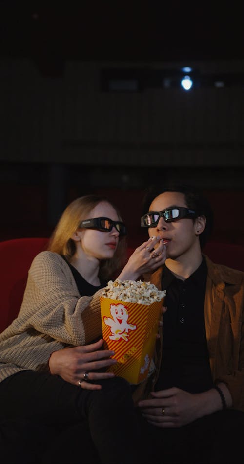 A Young Couple Watching 3D Movie in a Cinema