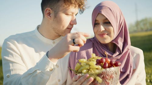 A Couple Eating Green Grapes