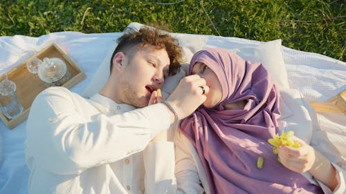 A Couple Eating Green Grapes