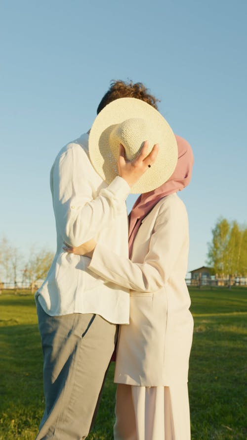 Couple Covering their Faces with a Hat