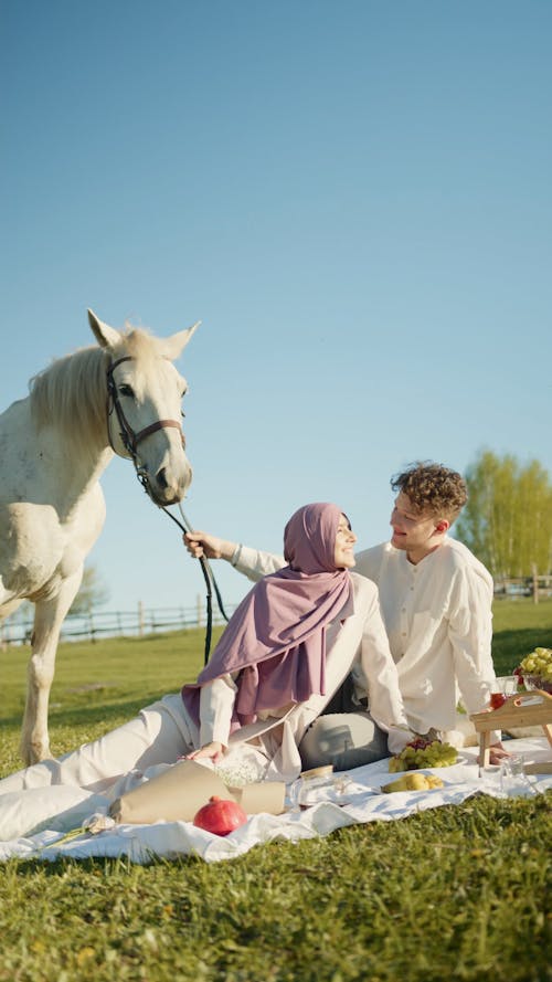Couple Having a Picnic with their Horse