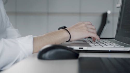 Close Up Shot of a Person Typing on the Laptop