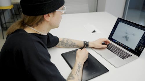 A Man Using a Graphics Tablet on Table