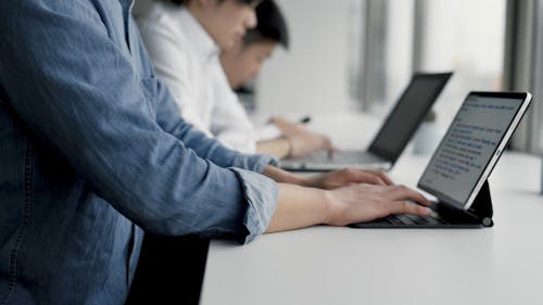 Men Busy Woking while using Laptop and Tablet