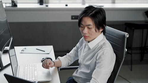 Man using Laptop and Tablet while Working
