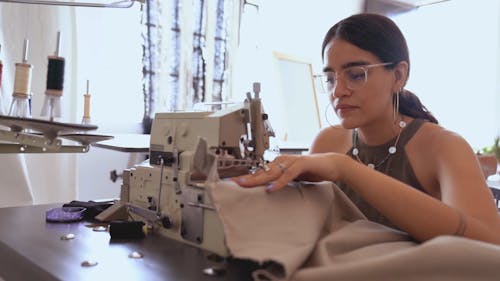 A Woman Using a Sewing Machine