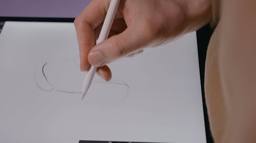 A Person Drawing on a Tablet