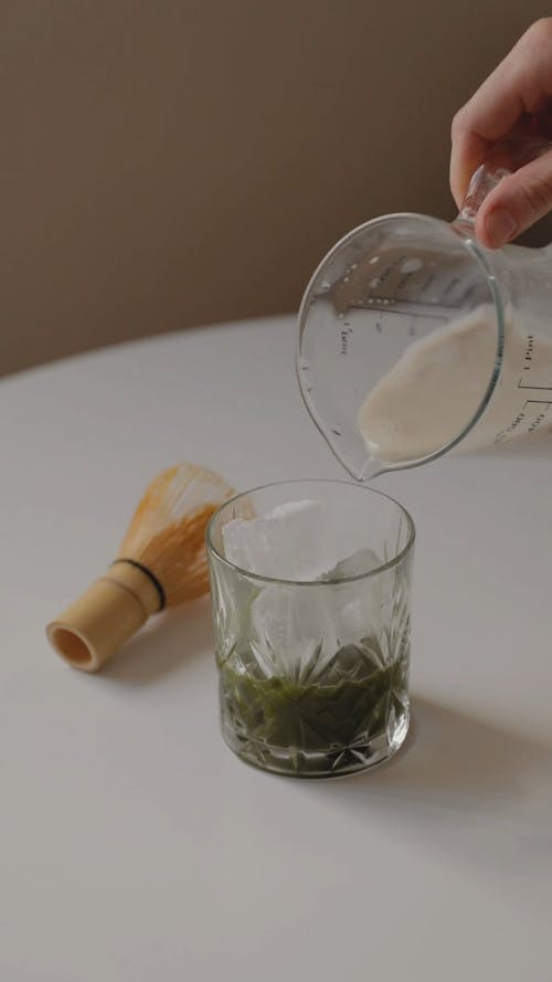 A Person Preparing a Matcha Latte